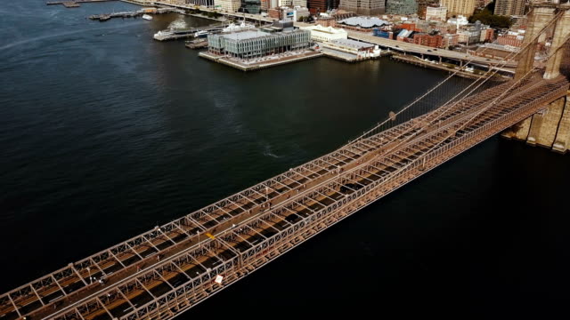 Aerial-top-view-of-the-Brooklyn-bridge-in-New-York,-America.-Drone-flying-over-the-East-river-to-Manhattan-district