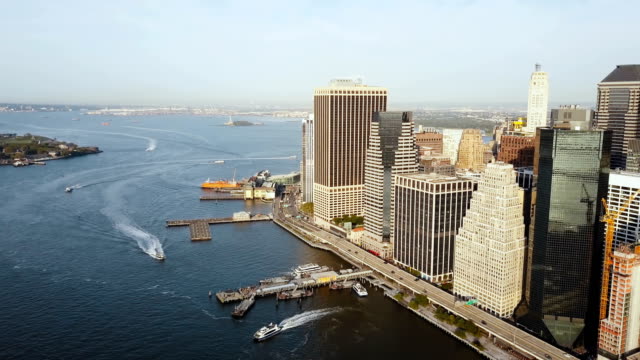 Aerial-view-of-the-Manhattan-in-New-York,-America.-Drone-flying-away-from-the-shore-of-East-river,-business-part-of-city