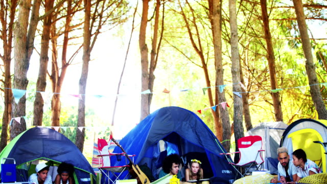 Couples-relaxing-on-tent-at-music-festival-4k