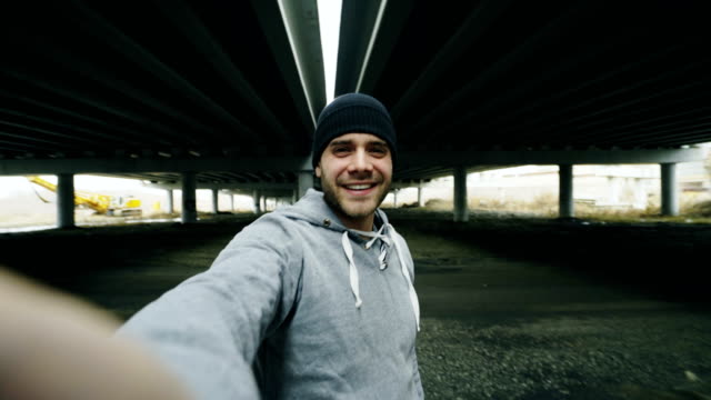 POV-of-Athlete-man-having-video-chat-on-smartphone-with-his-trainer-after-workout-at-urban-location-outdoors-in-winter