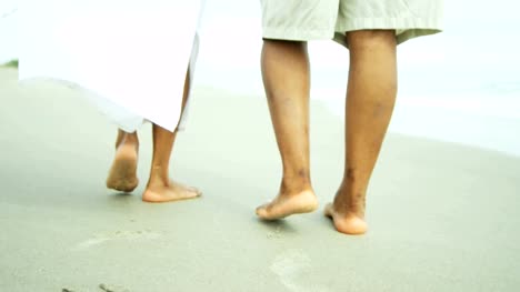 Legs-and-feet-of-ethnic-couple-walking-barefoot