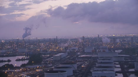 Flying-by-industrial-area-with-oil-refinery-in-early-morning.