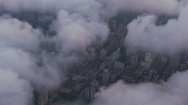Aerial-view-looking-through-low-clouds-at-Manhattan.