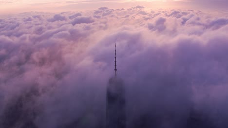 Aerial-view-of-One-World-Trade-Center-building-with-low-clouds-at-sunrise.