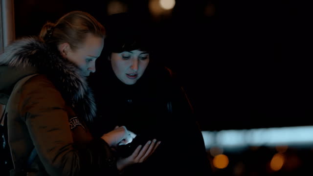Frauen-mit-digital-Tablette-in-Abend-Straße