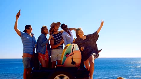Group-of-friends-taking-selfie-with-mobile-phone-4k