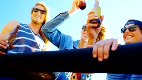 Group-of-friends-toasting-beer-bottles-in-the-car-4k