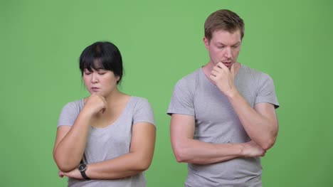Young-sad-multi-ethnic-couple-thinking-together