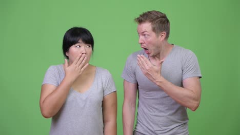 Young-multi-ethnic-couple-looking-shocked-together