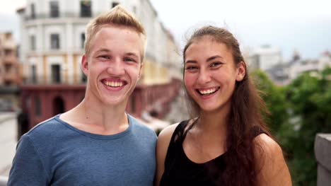 Happy-mixed-race-guy-and-girl-smiling-at-urban-street-on-summer