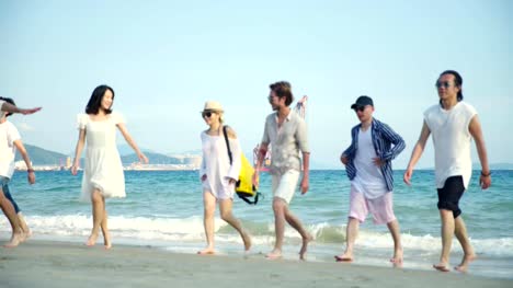 young-asian-adults-having-fun-on-beach