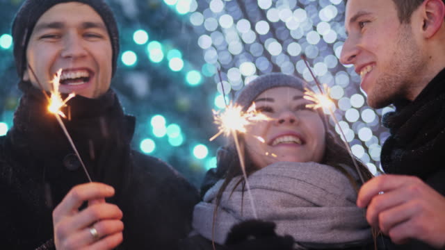 Three-close-friends-celebrating-New-Year-outdoors