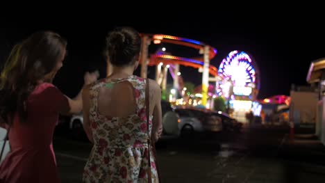 Two-friends-looking-at-a-carnival-from-a-distance