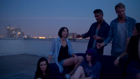 Hipster-girls-partying-around-a-couch-on-a-rooftop