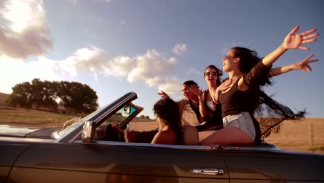 Teenager-friendspulling-faces-to-the-camera-on-road-trip
