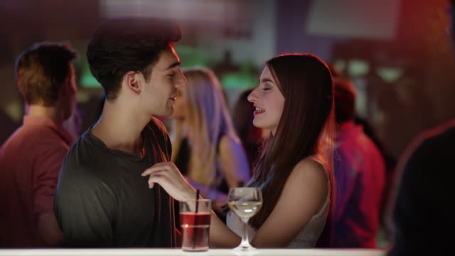 attractive-couple-kissing-at-bar-in-club