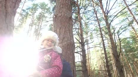 Boy-and-girl-sitting-on-a-large-tree.-The-children-have-planted-on-pine-tree-and-they-are-happy.-Sunday-holiday-with-children-in-the-park.