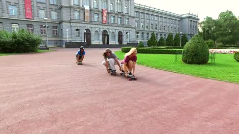 Happy-skateboarders-having-fun-riding-in-crouched-position