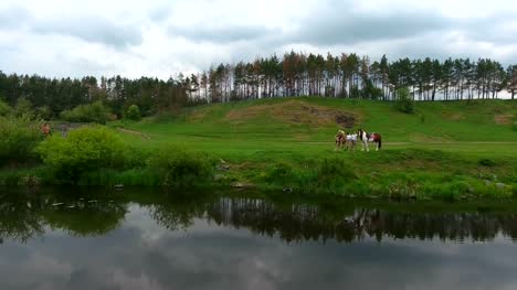 Couple-With-Horses-Standing-Near-The-River