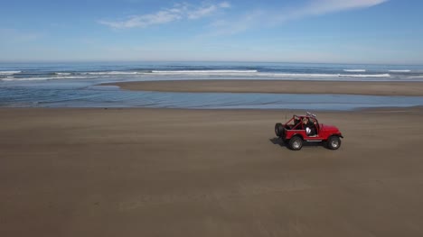 Aerial-shot-of-off-road-vehicle-driving-on-beach