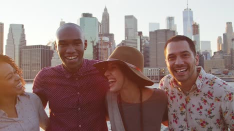 Portrait-Of-Friends-In-Front-Of-Manhattan-Skyline-At-Sunset
