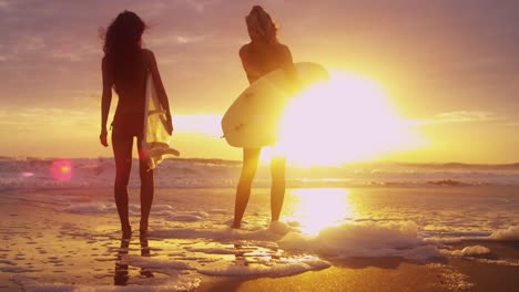 Multi-Ethnic-Surfer-Girls-Wearing-Bikinis-Sunrise-Silhouette