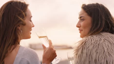 Two-girls-drinking-champaign-at-sunset