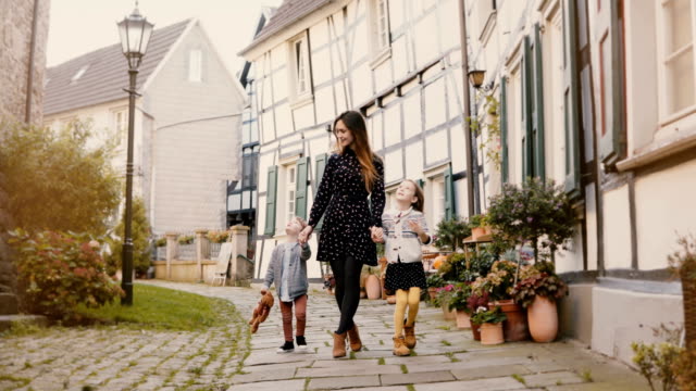 Beautiful-woman-walking-with-two-children.-Holding-hands.-European-mother,-girl-and-boy-together.-Hattingen,-Germany-4K