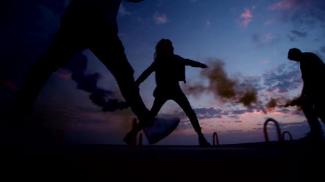 Hipster-friends-holding-smoke-bombs-and-running-after-sunset