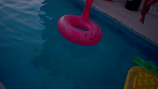 Women-on-summer-holidays-having-fun-jumping-into-swimming-pool