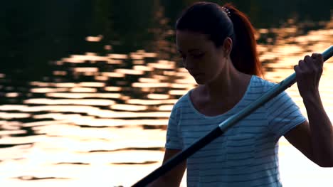 Close-up,-Beautiful-Girl-Picks-Oars-Standing-on-Sup