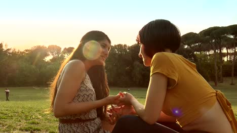 friendship,-women,-laughter--happy-friends-talking-and-smailing-at-the-park