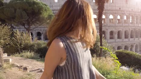 Schöne-junge-Frau-mit-langen-Haaren-führen-Freund-bei-der-Hand-in-Richtung-Kolosseum-in-Rom-bei-Sonnenuntergang-kommen-bei-mir-attraktive-glückliches-Paar