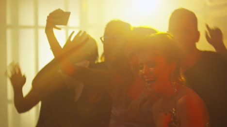 Joyous-Friends-Taking-Selfie-in-Nightclub