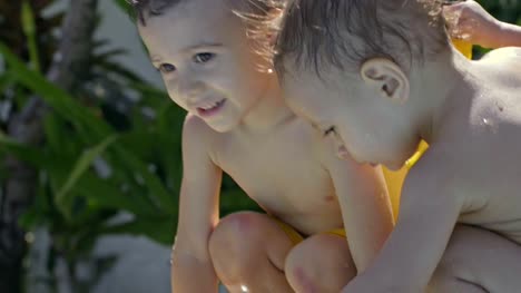 Little-Boys-Playing-with-Water-in-Swimming-Pool