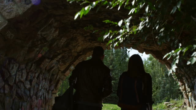 Couple-Walking-under-Stone-Bridge