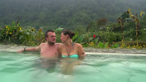 A-man-is-hugging-a-woman-in-a-pool-with-thermal-water