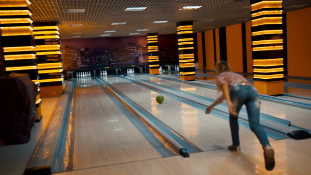 Friends-bowling-at-club-and-having-fun-playing-casually