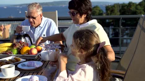 A-big-happy-family-has-dinner-on-the-open-terrace-on-the-roof-of-the-house.