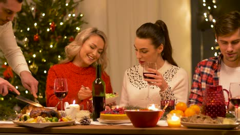 happy-friends-having-christmas-dinner-at-home