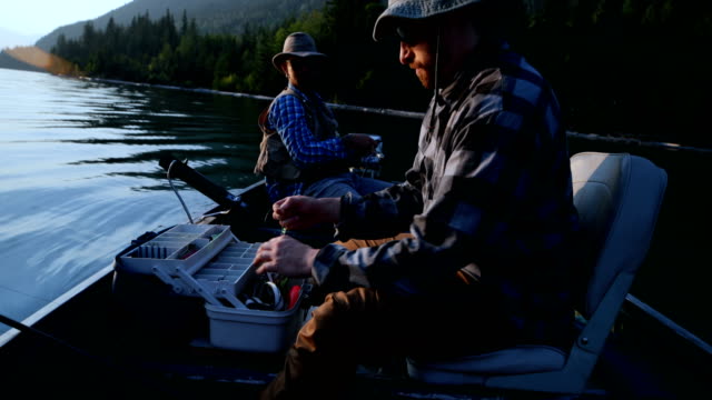 Two-fisherman-preparing-for-fishing-in-the-boat-4k