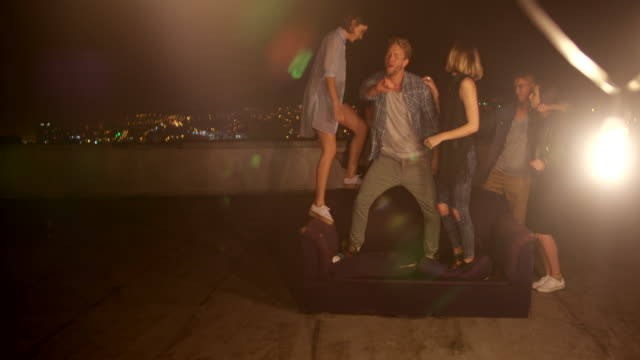 Teenager-friends-dancing-and-laughing-on-a-rooftop-party