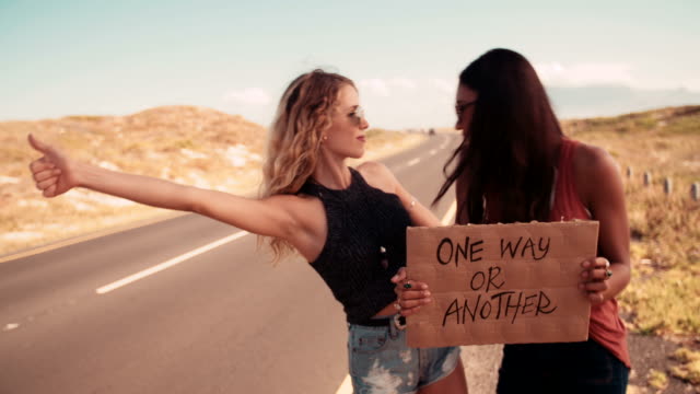 Two-Hipster-Girls-Hitchhiking-Together