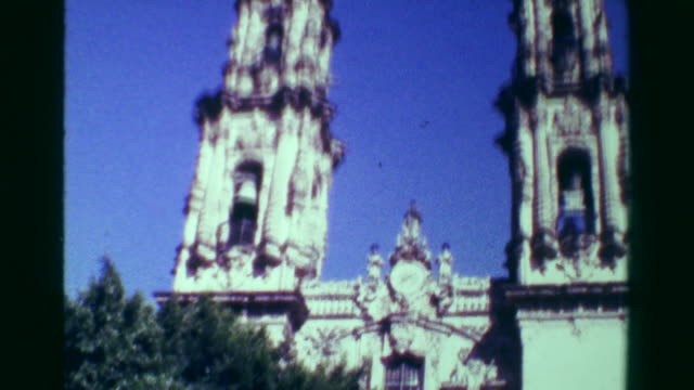 1978:-Religious-church-cathedral-building-tilt-down-blue-sky-sunny-day.