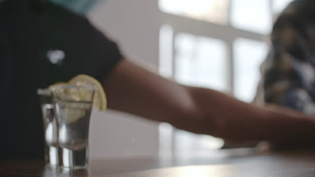 Barkeeper-Schiebe-Zitrone-Wodka-für-Kunden