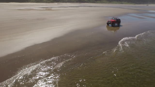 Aerial-shot-of-off-road-vehicle-driving-on-beach