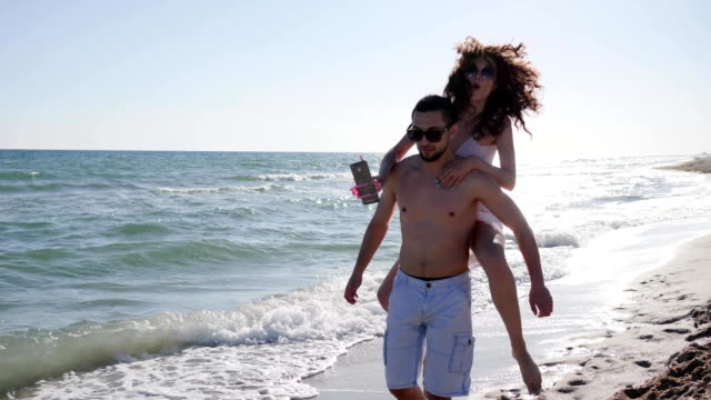 mobile-phone-on-Selfi-stick,-positive-young-people-shoot-video-from-holiday-travel,-love-couple-make-Selfi-photo-on-beach