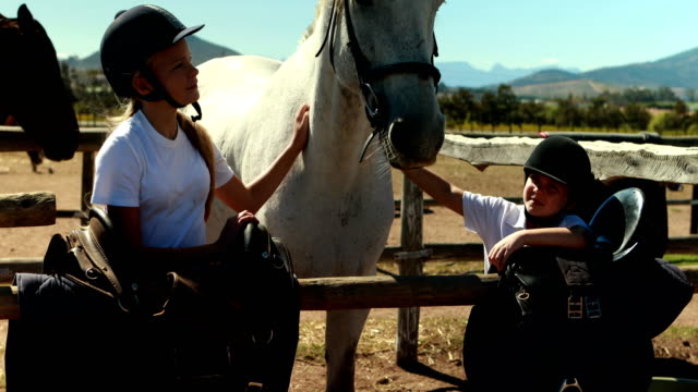 Siblings-touching-the-white-horse-in-the-ranch-4k