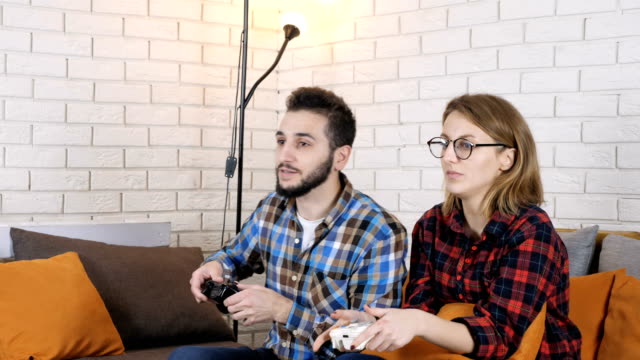Guy-with-a-girl-sitting-on-the-couch-and-playing-a-console-game-50-fps