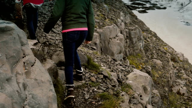 Gruppe-junger-Leute-zu-Fuß-durch-die-Felsen-wandern-in-Bergen-zusammen-in-der-Nähe-der-Vatnajökull-Eis-Lagune-in-Island